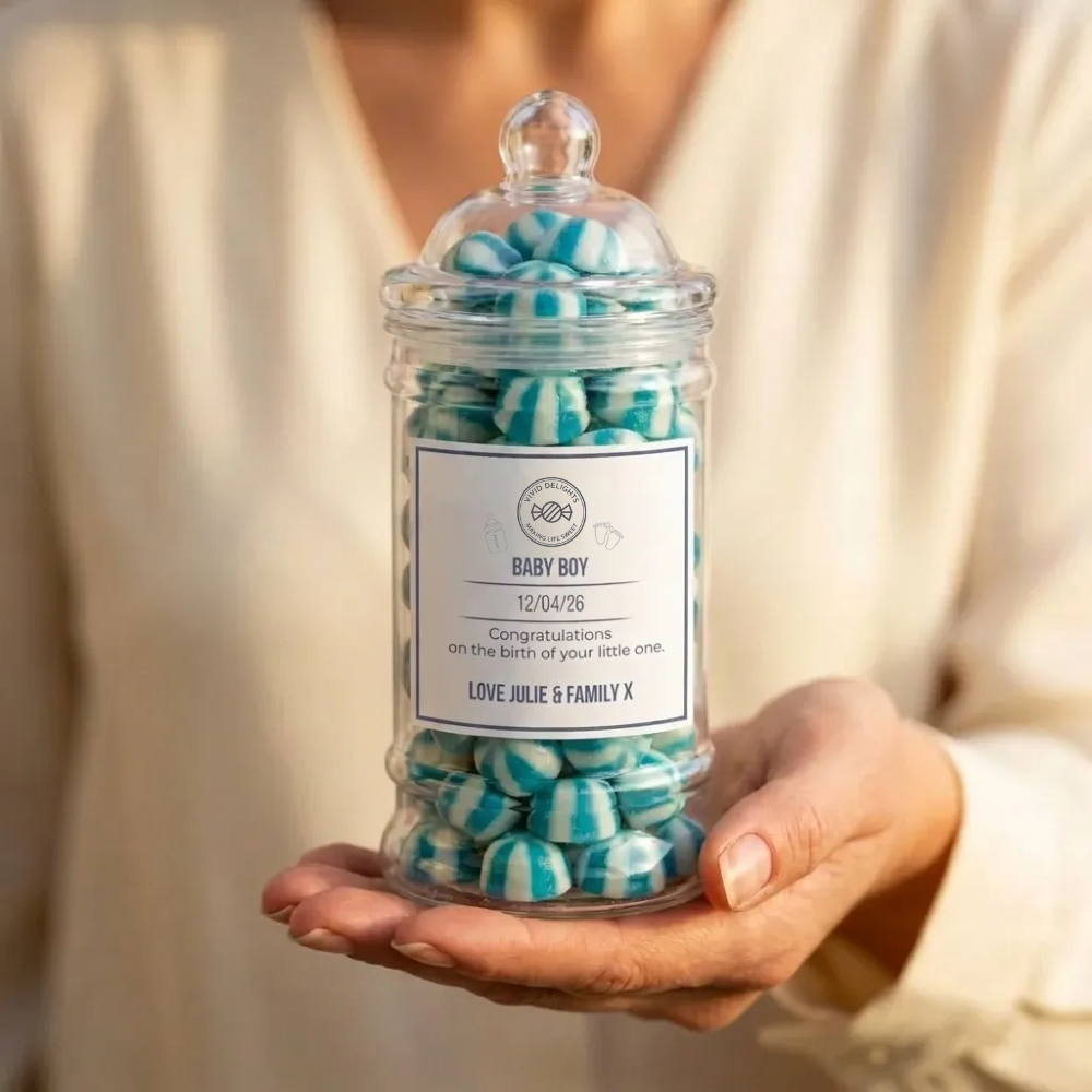 A Baby Boy personalised announcement sweet jar held in one hand