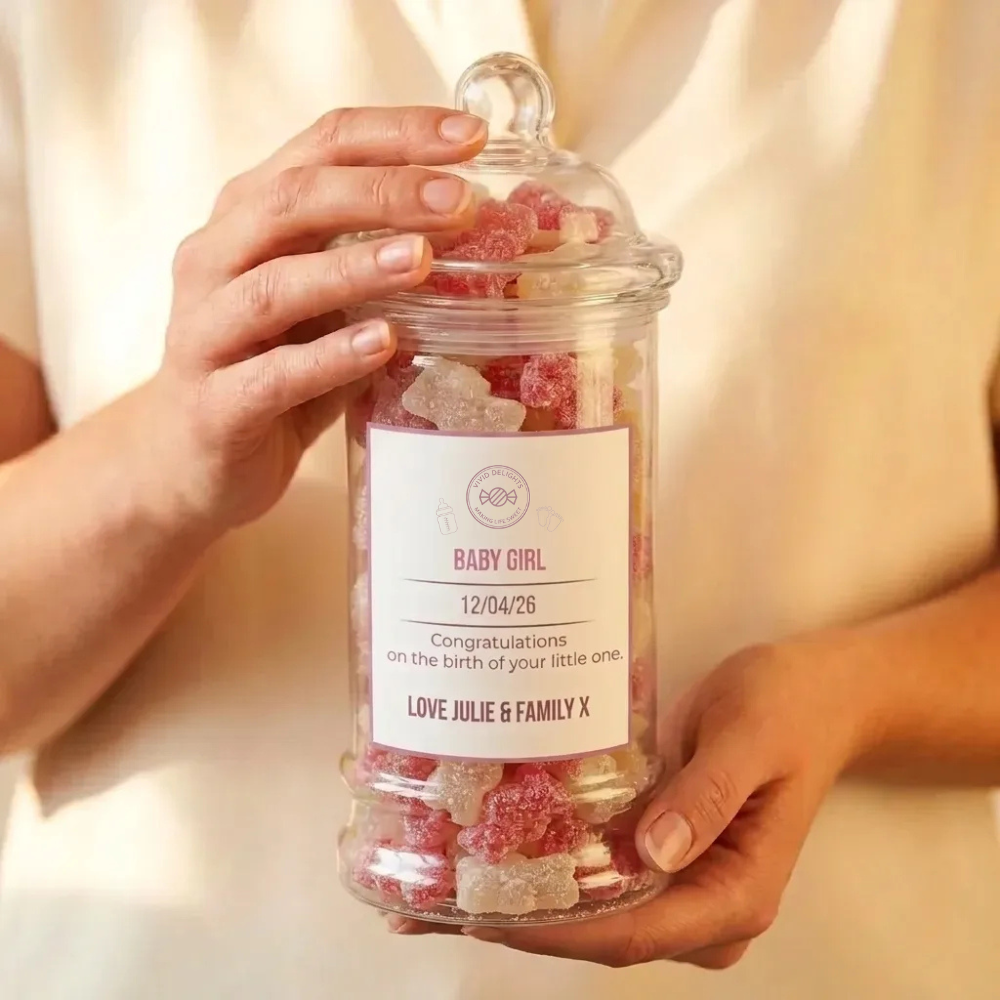 A Baby Girl personalised announcement sweet jar held in two hands
